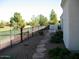 Landscaped side yard includes a stone pathway with golf course view and wrought iron fencing at 6832 S 38Th S Pl, Phoenix, AZ 85042