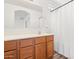 Bathroom featuring double sinks, a large mirror and a shower with a white curtain at 7815 W Monte Vista Rd, Phoenix, AZ 85035