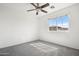 Bedroom with plush carpeting and large window providing ample light and neighborhood views at 7815 W Monte Vista Rd, Phoenix, AZ 85035