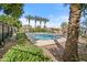 Community pool area with mature trees and covered seating at 7815 W Monte Vista Rd, Phoenix, AZ 85035