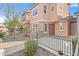 Beautiful townhome boasting stone accents, a wrought-iron fenced front porch, and manicured landscaping at 7815 W Monte Vista Rd, Phoenix, AZ 85035