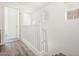 Upstairs hallway with carpeted steps and hardwood floors with natural lighting at 7815 W Monte Vista Rd, Phoenix, AZ 85035