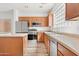 Modern kitchen featuring stainless steel appliances, wooden cabinets, and ample counter space for cooking at 7815 W Monte Vista Rd, Phoenix, AZ 85035