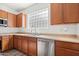 Functional kitchen featuring wooden cabinets, stainless steel appliances, and a bright window for natural light at 7815 W Monte Vista Rd, Phoenix, AZ 85035