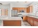 Well-lit kitchen with wooden cabinets, stainless steel appliances, and a center island at 7815 W Monte Vista Rd, Phoenix, AZ 85035