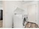 Bright laundry room with modern washer and dryer, and overhead shelving at 7815 W Monte Vista Rd, Phoenix, AZ 85035