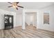 Bright living room with wood-look floors, ceiling fan, and kitchen entrance at 7815 W Monte Vista Rd, Phoenix, AZ 85035