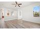 Bright living room featuring wood-look floors, an open layout with staircase and an inviting space with natural light at 7815 W Monte Vista Rd, Phoenix, AZ 85035