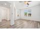 Bright living room with wood-look floors, ceiling fan and natural light at 7815 W Monte Vista Rd, Phoenix, AZ 85035