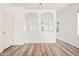 Bright living room showcasing an open layout, neutral color palette, durable wood-look floors, and an open archway at 7815 W Monte Vista Rd, Phoenix, AZ 85035