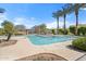 Community pool surrounded by palm trees and lush landscaping at 7815 W Monte Vista Rd, Phoenix, AZ 85035