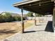 Covered backyard patio with brick pillars, string lights, and paver flooring at 8139 W Columbine Dr, Peoria, AZ 85381