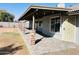 Covered backyard patio with pavers, stone pillars, and access to the backyard at 8139 W Columbine Dr, Peoria, AZ 85381