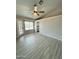 An empty bedroom features gray walls, wood-look flooring, and a door to the outside at 8139 W Columbine Dr, Peoria, AZ 85381