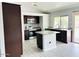 Well-lit kitchen features granite countertops, stainless steel appliances, and dark wood cabinetry at 8139 W Columbine Dr, Peoria, AZ 85381