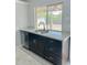 Kitchen area with a stainless steel dishwasher, granite countertops, and view of the backyard at 8139 W Columbine Dr, Peoria, AZ 85381