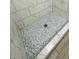 Close-up of mosaic tile shower floor with light blue and grey tiles at 8139 W Columbine Dr, Peoria, AZ 85381