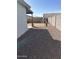 Well-maintained side yard with gravel, leading to a backyard featuring a playhouse and block walls at 8139 W Columbine Dr, Peoria, AZ 85381