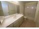 Updated bathroom features a single sink vanity, framed mirror and a bathtub/shower combination for convenience at 8255 E Kiva Ave # 424, Mesa, AZ 85209