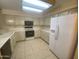 Bright kitchen featuring white cabinets, tile flooring, and a full suite of appliances for a functional cooking space at 8255 E Kiva Ave # 424, Mesa, AZ 85209