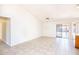 Open living room with tile flooring, a ceiling fan, and sliding glass doors to the backyard at 8818 N 110Th Ave, Peoria, AZ 85345