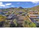 Overhead view of a home featuring a horse arena, barn, and mountain views at 9331 E Mclellan Rd, Mesa, AZ 85207