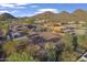 Aerial view of desert home featuring a horse arena, barn, and mountain views at 9331 E Mclellan Rd, Mesa, AZ 85207