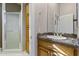 Bathroom featuring a vanity with granite countertop, wood cabinets and a walk-in shower at 9331 E Mclellan Rd, Mesa, AZ 85207