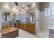 Bathroom with double sinks, vanity, and a glass block walk-in shower at 9331 E Mclellan Rd, Mesa, AZ 85207