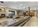 Bright living room with fireplace, large windows, and views of the outdoor landscape at 9331 E Mclellan Rd, Mesa, AZ 85207