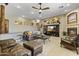 A cozy living room featuring a fireplace, TV, and comfortable furniture at 9331 E Mclellan Rd, Mesa, AZ 85207