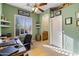 Inviting office with green walls, shuttered window, and a glimpse of the en-suite bathroom at 9331 E Mclellan Rd, Mesa, AZ 85207