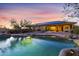 Backyard pool at sunset, a tranquil oasis with desert landscaping at 9331 E Mclellan Rd, Mesa, AZ 85207