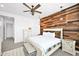 Well-decorated bedroom featuring a rustic wood accent wall and modern ceiling fan at 993 E Knightsbridge Way, Gilbert, AZ 85297