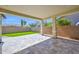 Covered patio area features travertine pavers with views of the low-maintenance backyard at 993 E Knightsbridge Way, Gilbert, AZ 85297