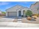 Charming single-story home with a landscaped front yard, arched entryway and two car garage at 993 E Knightsbridge Way, Gilbert, AZ 85297