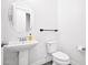 Bright powder room features a pedestal sink, round mirror, and modern fixtures at 993 E Knightsbridge Way, Gilbert, AZ 85297