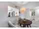 Cozy dining nook with a round table, stylish lighting, and open view to the modern kitchen at 11011 N 92Nd St # 1157, Scottsdale, AZ 85260