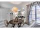 Bright dining area open to the living room boasts a stylish light fixture and modern furnishings at 11011 N 92Nd St # 1157, Scottsdale, AZ 85260