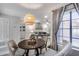 Bright dining room with a wood table, stylish light fixture, and open access to the living room at 11011 N 92Nd St # 1157, Scottsdale, AZ 85260