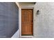 Stunning multi-panel wooden front door with decorative carvings and modern smart lock at 11011 N 92Nd St # 1157, Scottsdale, AZ 85260