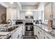 Modern kitchen with white cabinets, stainless steel appliances, and granite countertops at 11011 N 92Nd St # 1157, Scottsdale, AZ 85260