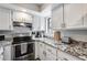 Bright kitchen featuring granite countertops, stainless steel appliances, and ample cabinet storage at 11011 N 92Nd St # 1157, Scottsdale, AZ 85260