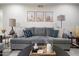 Comfortable living room featuring a gray sofa accented with decorative pillows, complemented by desert-themed wall art at 11011 N 92Nd St # 1157, Scottsdale, AZ 85260