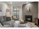 Cozy living room featuring a fireplace, a comfortable sofa, and decor with a desert motif at 11011 N 92Nd St # 1157, Scottsdale, AZ 85260