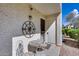 Inviting patio with a table, two chairs, and a compass wall decoration, great for outdoor relaxing at 11011 N 92Nd St # 1157, Scottsdale, AZ 85260