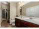 Bathroom featuring double sinks, wood cabinets, and a tile floor, providing ample space at 11023 E Shepperd Ave, Mesa, AZ 85212
