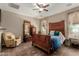 Bedroom featuring decorative wood furniture, large windows, and a ceiling fan at 11023 E Shepperd Ave, Mesa, AZ 85212