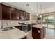 Modern kitchen featuring stainless steel appliances, an island, and dark wood cabinets at 11023 E Shepperd Ave, Mesa, AZ 85212