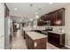 Open kitchen with stainless steel appliances, central island, and view to the living room at 11023 E Shepperd Ave, Mesa, AZ 85212